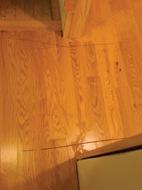 Photo of cuts made into wood floor