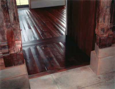Reclaimed oak was dyed brown, then was coated with a light oil stain and two coats of a waterborne finish.