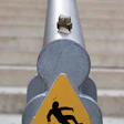 photo of sign with person slipping on stairs