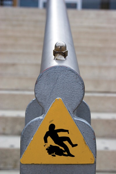 photo of sign with person slipping on stairs