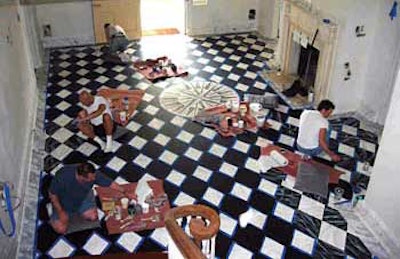Artisans precision-ply their paintbrushes to achieve this faux-marble look on the Gracie Mansion wood floor. (Photo courtesy The Alpha Workshops)
