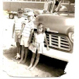 photo of three children in front of a 1957 Chevy
