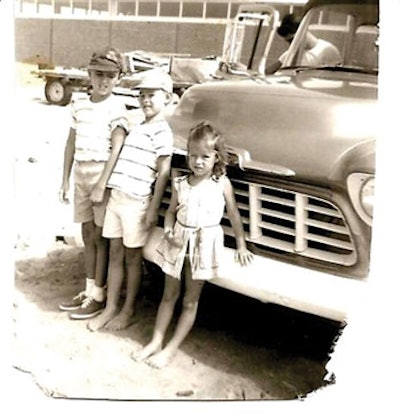 photo of three children in front of a 1957 Chevy