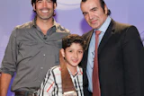 Avedis Duvenjian of Wood Floor of the Year Members' Choice winner Archetypal Imaginary Remodeling Corp. and his son Tigran with HGTV celebrity Carter Oosterhouse (left) at the 2012 NWFA Expo in Orlando, Fla., on April 12. (Photo courtesy David Stluka)