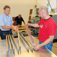 Inside the Forest Products Lab in Madison, Wis., Engineer John Hunt, left, and Jubilee Flooring's Joe Triglia inspect old wine barrel staves straightened using microwave-drying technology. (Photo courtesy of USDA's Forest Products Lab)