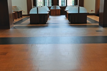 (AFTER) In the after pic, you may think those ripples are from the drum sanding or from the finish, but they are actually the cork flooring conforming to the substrate, which was never flattened before the original installation. With careful sanding we were able to strip the cork floor without removing an excessive amount of it.