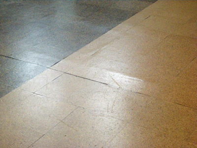 (BEFORE) This close-up shot clearly shows a ridge that is present in the subfloor; a challenge was to sand over all the irregularities without tearing apart the cork.