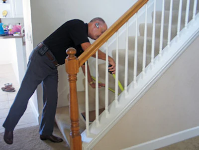Williford takes measurements during an initial client meeting for a staircase remodel job. Most of his appointments like this are the result of radio advertising or an Internet search.