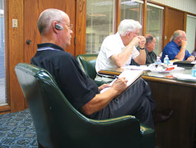 Williford takes notes during a meeting of one of the two civic clubs of which he is a member. That day the President's Roundtable decided on recipients for college scholarships and public safety servant awards.