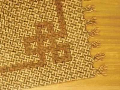 After installing all the blocks, Campbell painted on tassels to make the rug appear move convincing.