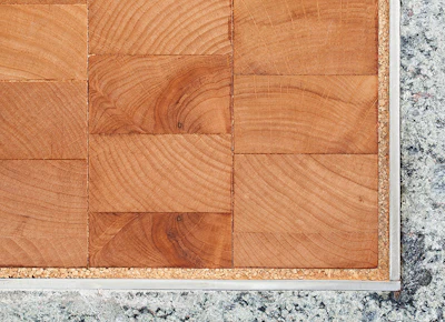 A 1/4-inch cork strip was installed where wood flooring met other floor coverings to accommodate expansion.