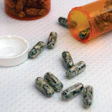 photo of money in pill capsules