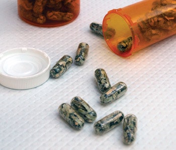 photo of money in pill capsules