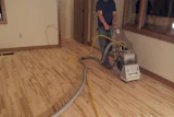 Bob Kalma Sanding the Dwyers new maple wood floors on his own time. Photo Courtesy of Matt Thrane.