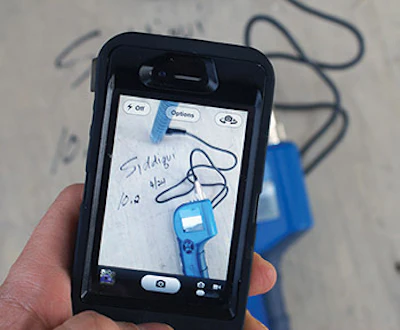 With cameras on every phone, it's easier than ever to take photos of the job site. Write the name of the job, the date and the results on the subfloor, and take photos of your readings. (Photo by Scott Taylor)