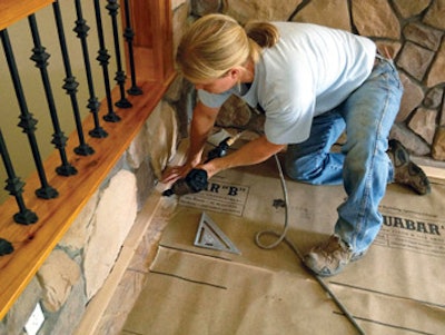 photo of a person working on flooring