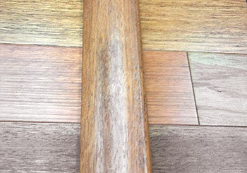 Here a stock overlap reducer in natural Brazilian cherry is shown on top of a prefinished natural Brazilian cherry floor with all the varied colors in natural Brazilian cherry. Making sure that the flooring directly adjacent to the molding is a close color match can help reduce complaints.