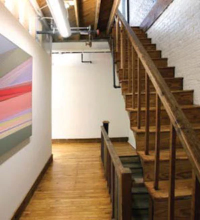 A reclaimed wood baseline lines the hallway as a plastic wall coating helps distribute light throughout the building.(Mark Lamkin Photography)