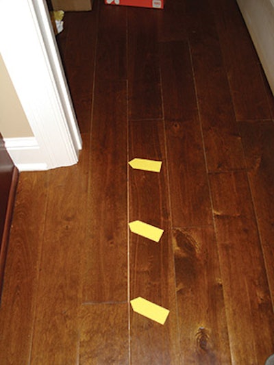 Seasonal gaps can look particularly troublesome when they appear in a dark-stained factory-finished floor like this, exposing the lighter-colored unstained wood (this is a stained solid birch product). (All photos by Roy Reichow)