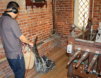 Sanding the floor next to the bell controls.