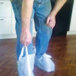 photo of a wood worker using plastic bags for booties