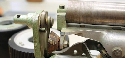 On this upper roller, the guide roller is worn out. The bearing seized, and the paper ate away the metal, which would have caused the tracking to be off, which can cause chatter on the floor, too.