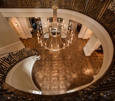 White oak was selected for the award-winning floors throughout this traditional home. At the bottom of this dramatic stairwell, it is crafted into a traditional Marseille pattern and burnished with oil for a finish that is warm and welcoming.