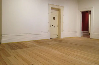 The large patched area in the main gallery is where the hearth for the original 1884 fireplace was located—keeping the staff and customers warm while counting their money.