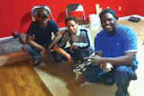 Burden's students after practicing how to stain a wood floor.
