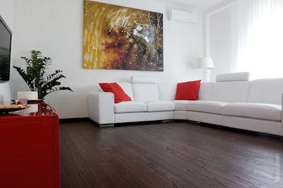 This 6-inch plank floor is a thermally modified ash floor glued direct to concrete with radiant heat in Milan, Italy, and has a rubbed oil finish. (Photo courtesy of Thermory USA)