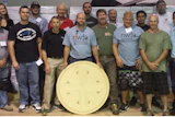 The students at NWFA's Intermediate Installation school, held May 18–21 in Kennesaw, Ga., stand with a medallion.