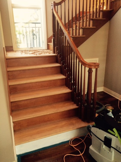 Scraping the cherry stair treads.