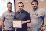 Kjell Nymark (left) and Rob Zehnder (right) pose with David Watson, the first citizen of the United Kingdom to receive an NWFACP certification.