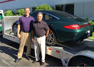 Al Futscher (left) and Tony Roberto of CDC Distributors stand in front of a Porsche 911, which they won the right to use for one month this summer.