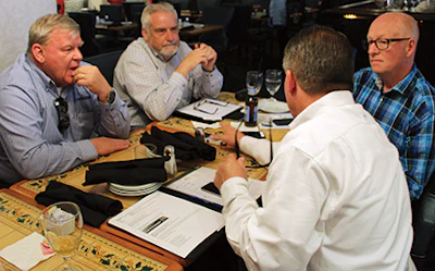 Hart talks about running a large retail and installation company with managers from another large company, Flooring Solutions, over drinks the day before the NWFA Expo.