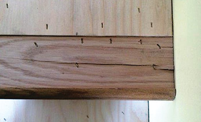 A bird's-eye view of a poorly installed tread. Incorrect staple placement has caused this profile to crack upon installation. Also, no flooring was installed over the profile at the time of install, leaving it more susceptible to further damage and failure. - Click to enlarge