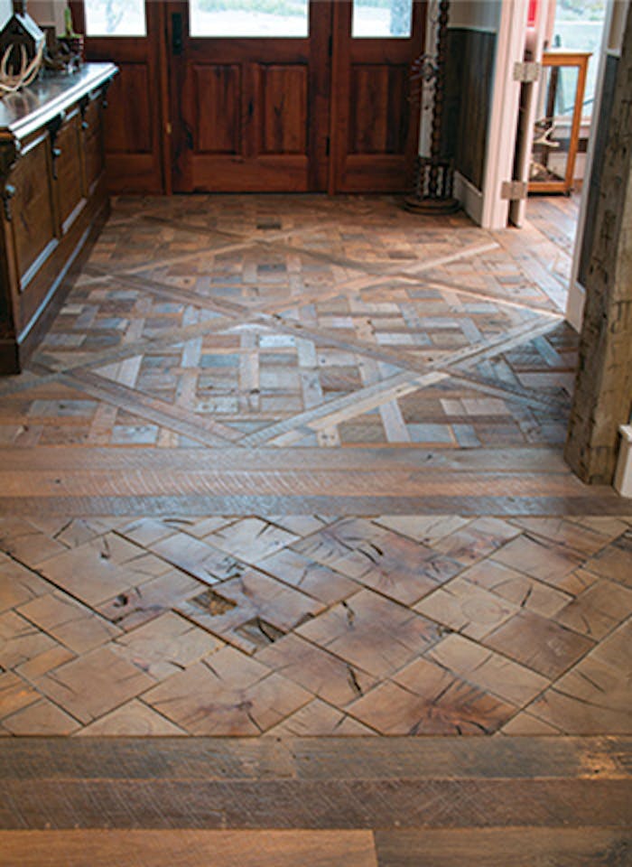 The house strikes a balance between hominess and sophistication. Nowhere is this more clear than the reclaimed wood Versailles and end-grain block patterns in the entryway. (Steve Chenn Photography)