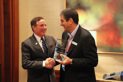 Bruce Zwicker of Haines (at left) presents the company’s Supplier Reliability Award to Mirage President Pierre Thabet.