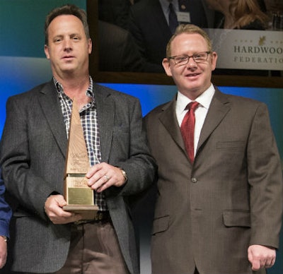 Steve Welch (left) accepts the 2015 Wood Floor of the Year–Best CNC/Laser Cut award from NWFA Chairman Jeff Fairbanks.