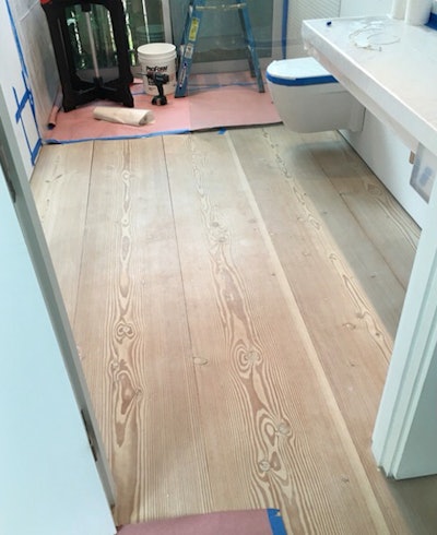 A cupping 18-inch-wide Doug fir wood floor.