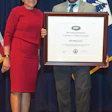 David Old holds the President's 'E' Award for Export next to U.S. Secretary of Commerce Penny Pritzker in Washington D.C.
