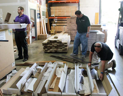 Graham chooses flooring boards from each box to make true-to-life samples for Hardwood Giant customers.