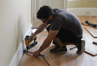 Rodrigo Pereira installs the final pieces of flooring at the military veteran’s home.