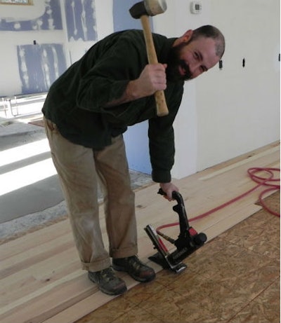 ​Charlie Hunter from Birmingham, Ala., nailing down Timbergreen's wood in a remodeling job in Madison, Wis..