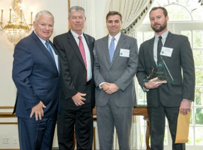 Accepting the award are, from left, Keith Campbell, chairman of the board; Russell Grizzle, president and CEO; Zack Zehner, senior vice president of distributor network; and Ian Campbell, senior analyst of segment strategy.