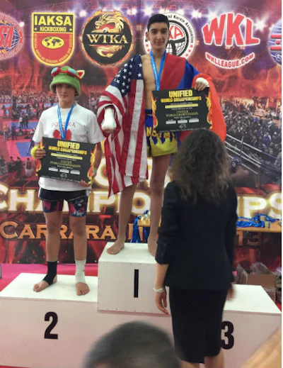 Tigran Duvenjian, draped in the American flag, won the Muay Thai Kickboxing World Championship in October.