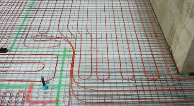 A roughed-in basement floor showing radiant tubes before the poured-in cement. Places where many tubes converge (oftentimes at doorways) can create hot spots in the floor. (Photo courtesy of Radiant Professionals Alliance)