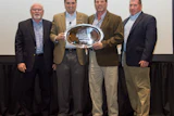 Zack Zehner, senior vice president of distribution network at Mannington (second from left) presents the John B. Campbell Award to Elias Wilf management (from left) Brian Campbell, vice president of sales, central region; Jeff Striegel, president; and Bryan Campbell, vice president of sales, commercial.
