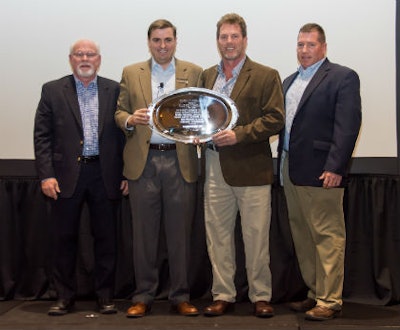 Zack Zehner, senior vice president of distribution network at Mannington (second from left) presents the John B. Campbell Award to Elias Wilf management (from left) Brian Campbell, vice president of sales, central region; Jeff Striegel, president; and Bryan Campbell, vice president of sales, commercial.