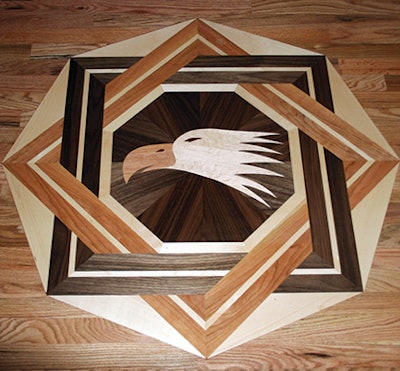 I cut the eagle's head in this inlay out of maple and cherry. The eye is padauk, and the surrounding inlay has walnut, maple and cherry.